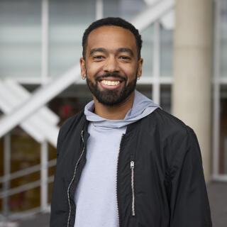 Black man in grey hoodie and jacket