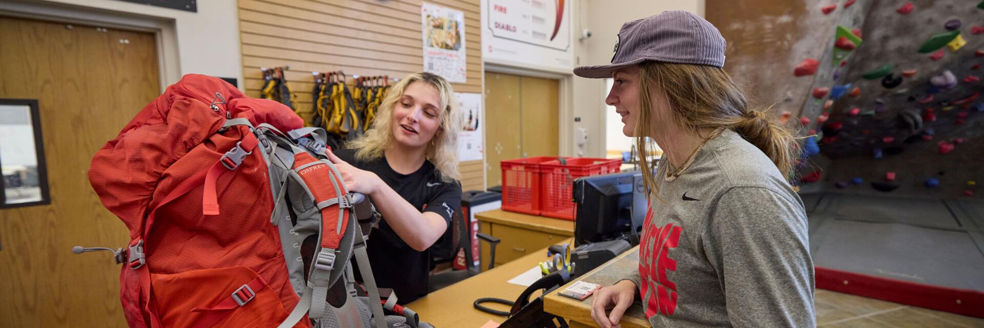 Student renting a backpack from Outdoor Adventure Center