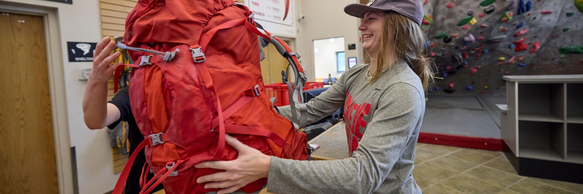 Student renting a camping backpack at the OAC