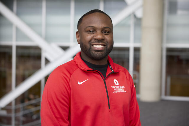 Black male in a red jacket