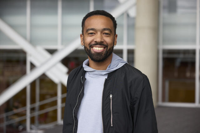 Black man in grey hoodie and jacket