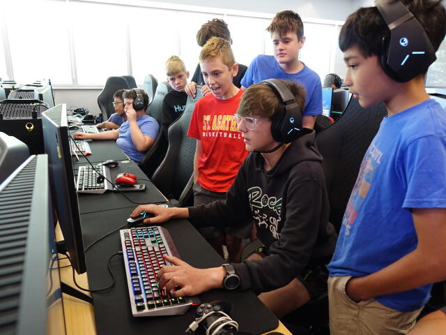 Kids playing computer game at summer camp