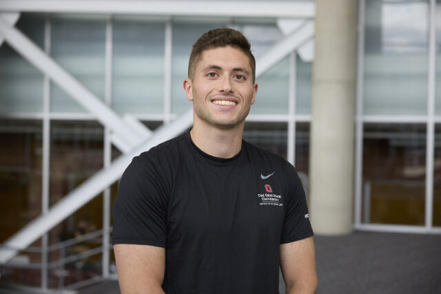 male, black shirt, short dark hair