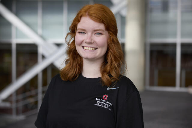 Woman, red hair, black jacket