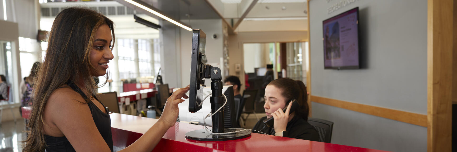 Student using touchscreen at RPAC Welcome Center